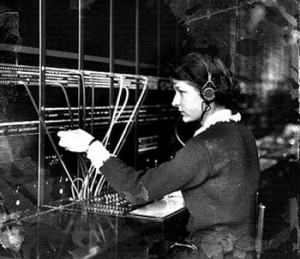 Early telephone operator at manual plug and wire switchboard